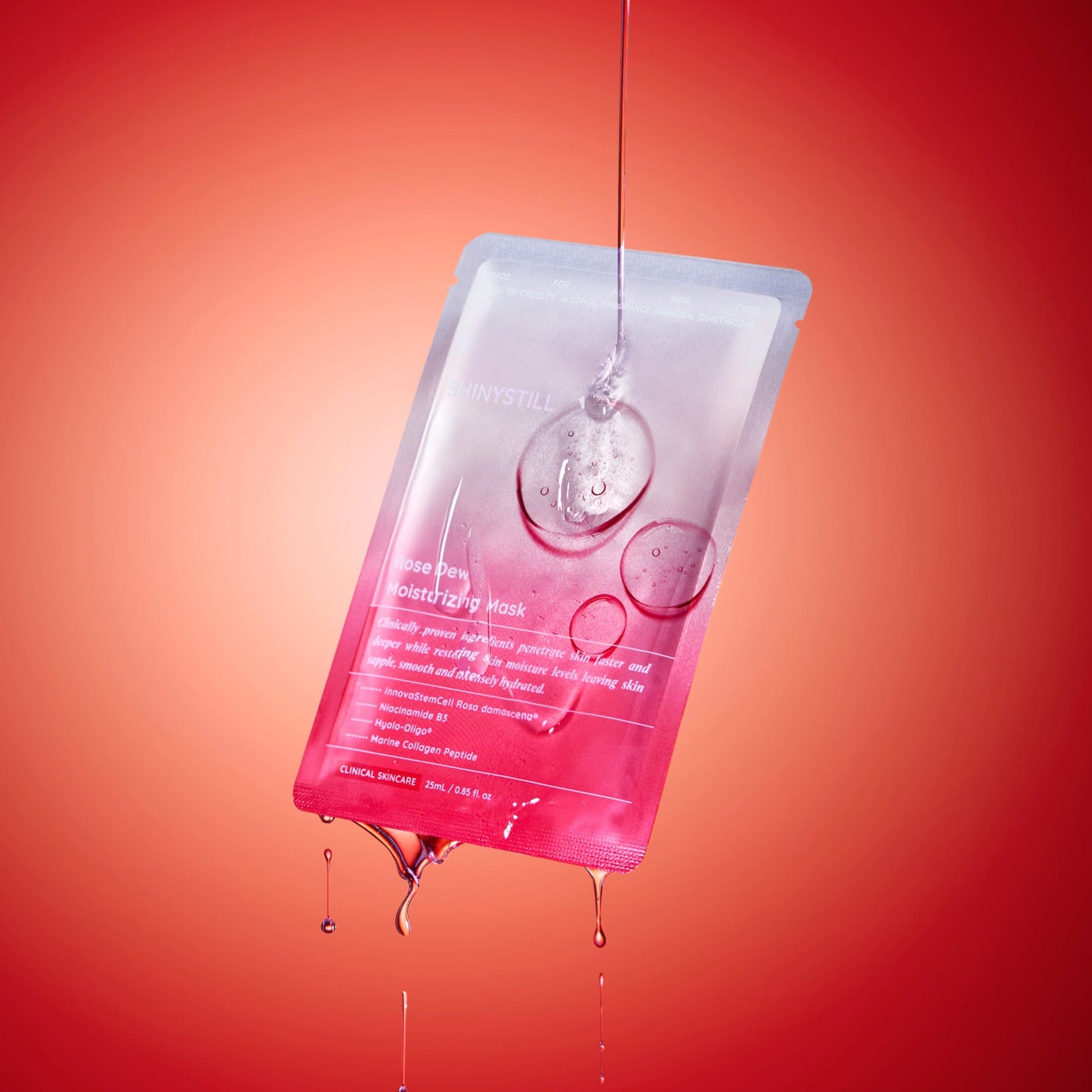 Pink skincare sheet mask with water droplets on a red background