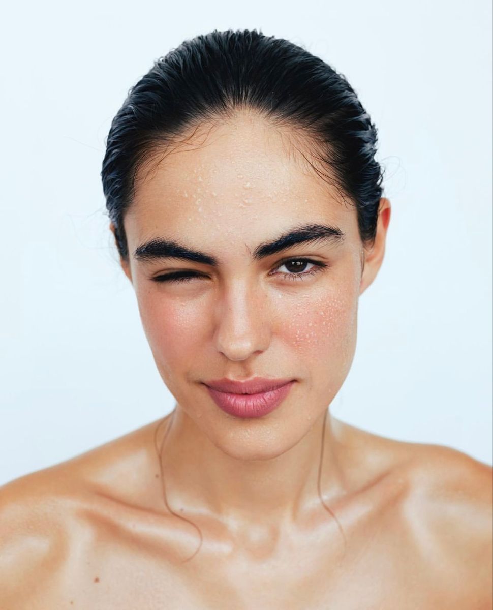 Close-up of a woman with a plain background