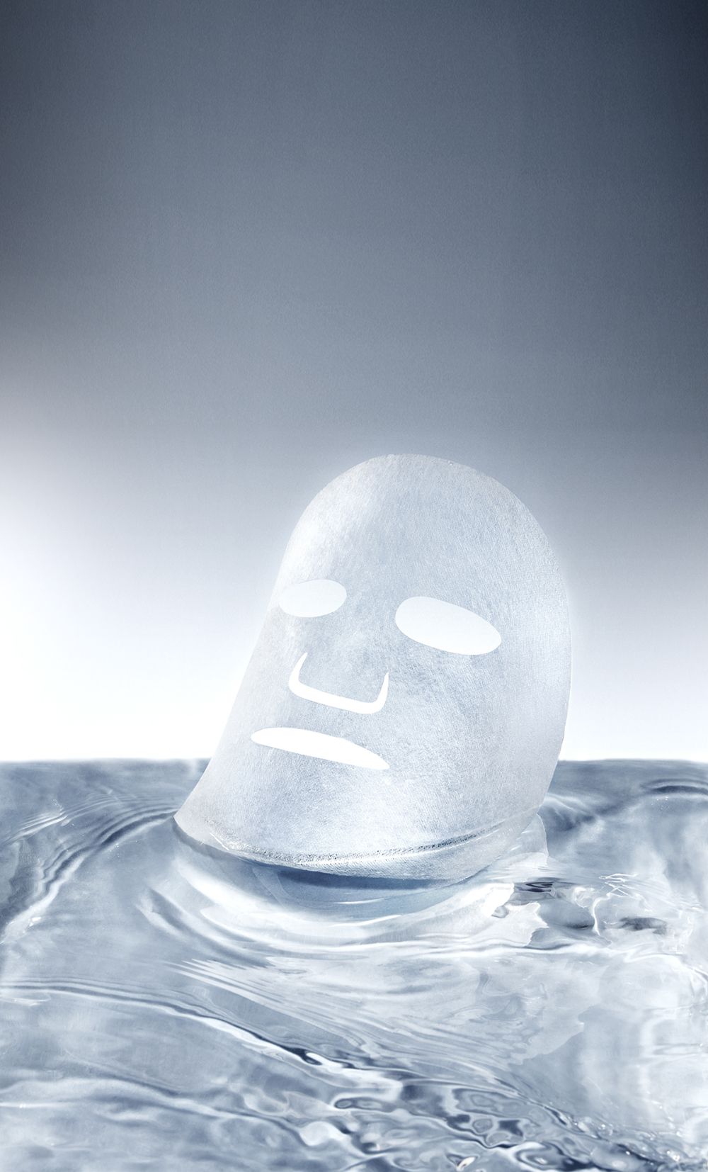 Ice sculpture of a face on water with a gray background
