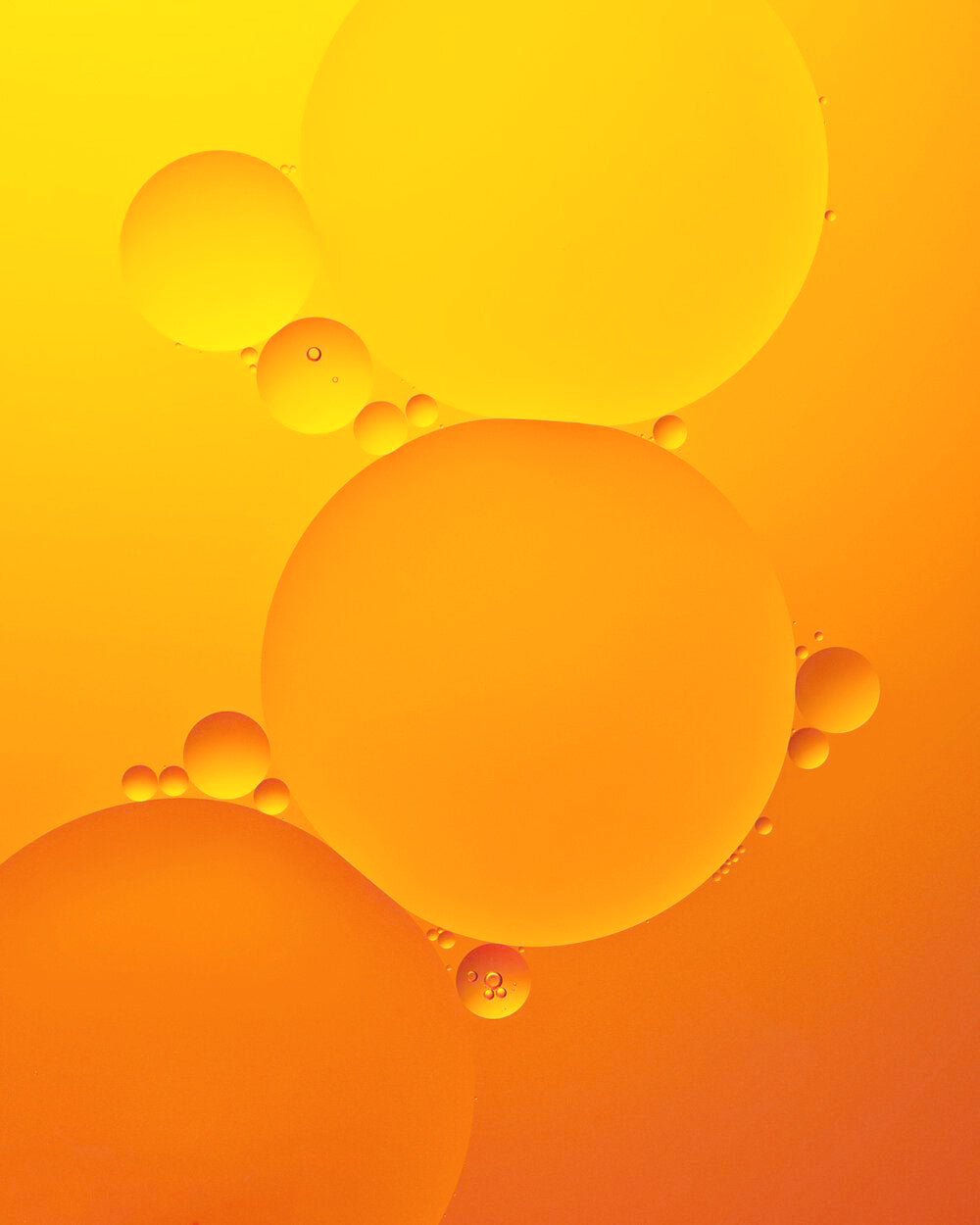Close-up of orange and yellow bubbles on a gradient background
