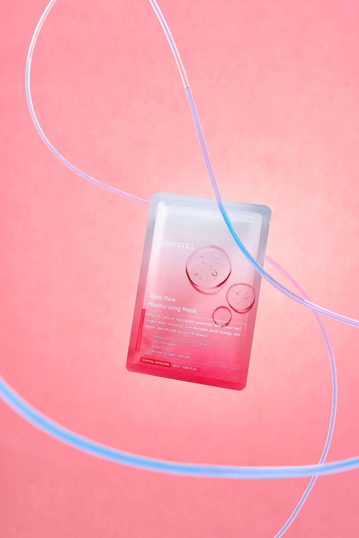 Sheet mask packaging on a pink background with decorative lines