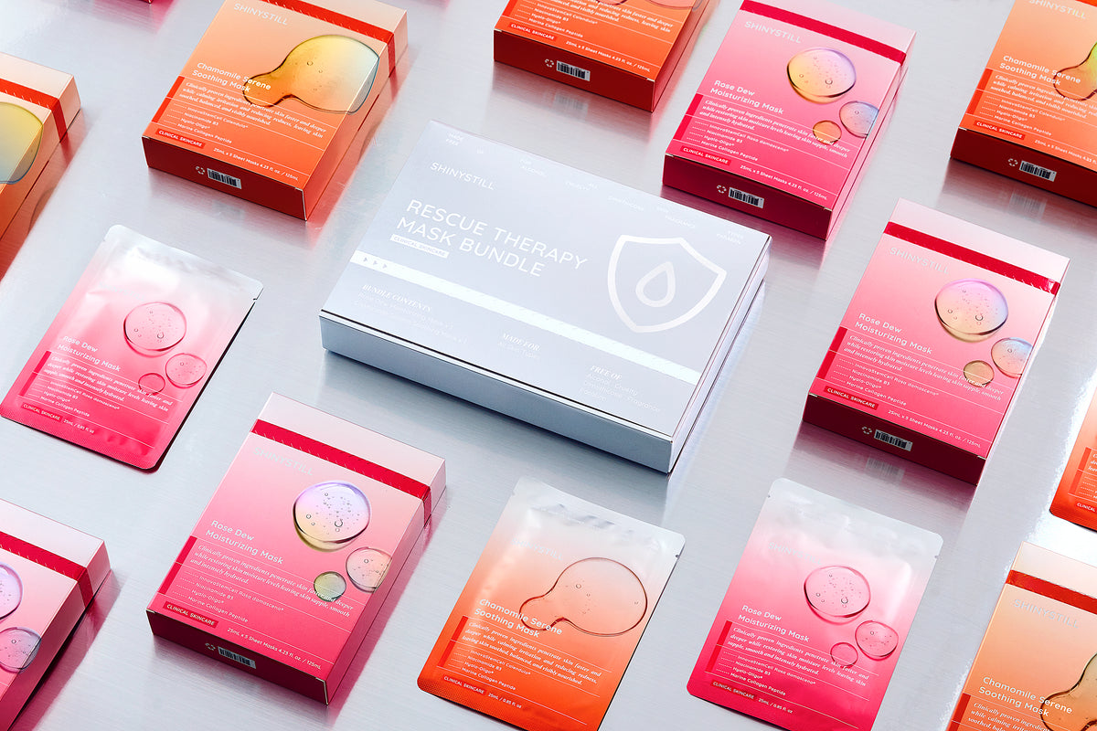 Skincare product packaging with pink and orange boxes on a light gray background
