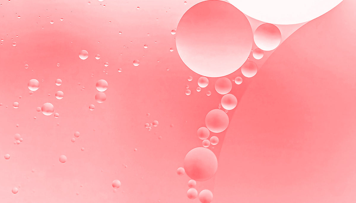 Pink background with oil bubbles