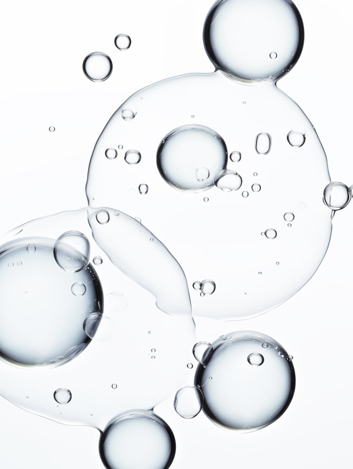 Clear bubbles of various sizes on a white background